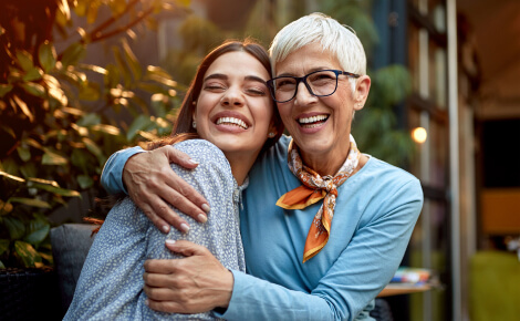 A young woman and older woman embracing