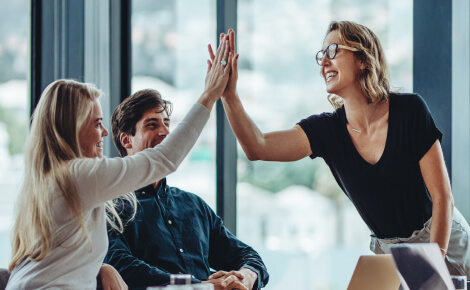 Group of office coworkers reaching for a high-five