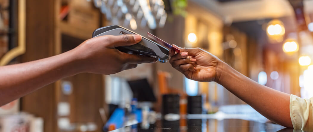 a person making a purchase with a debit or credit card